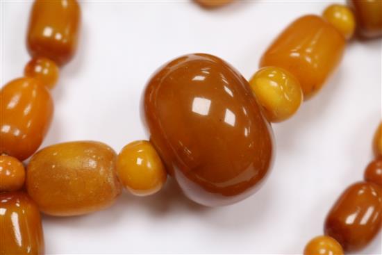 A part amber bead necklace and a pair of amber bead earrings.